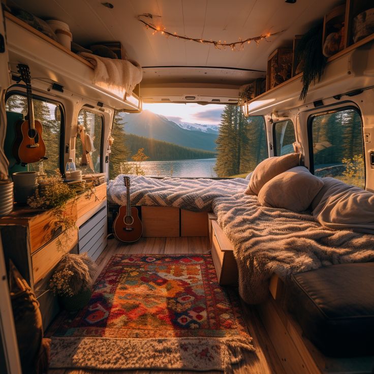 the interior of an rv with a bed, guitar and rug in front of it