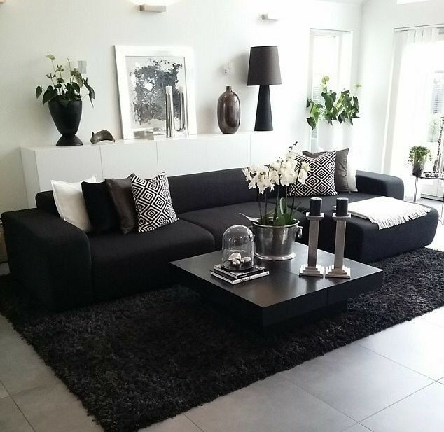 a living room with black and white decor