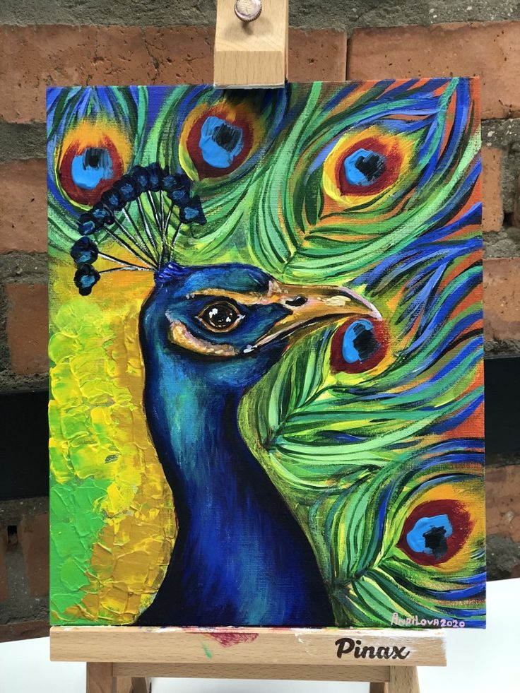 a painting of a peacock with feathers on it's head is shown in front of a brick wall