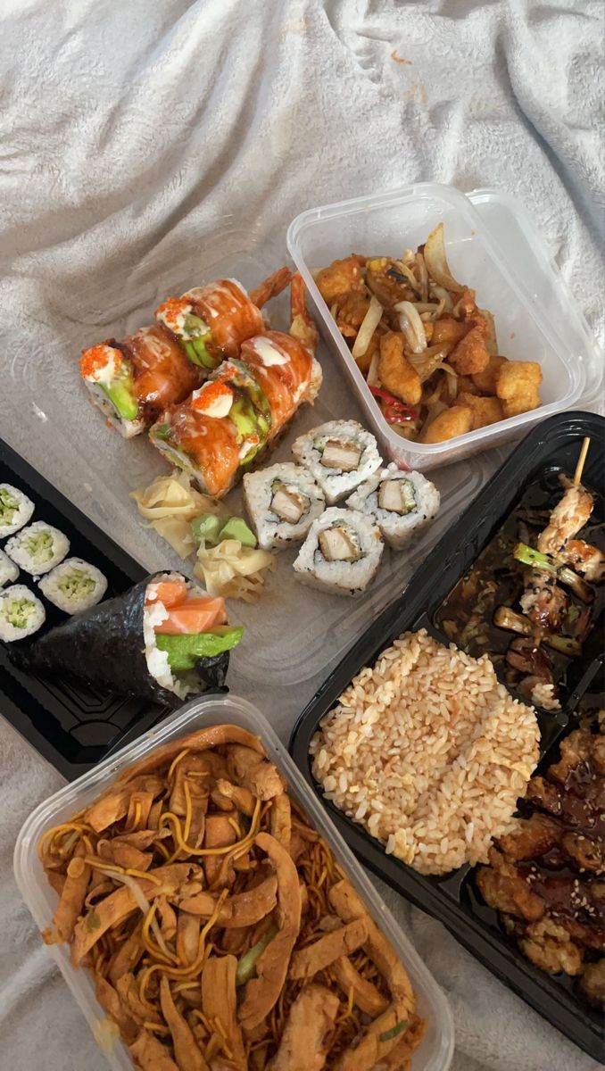 there are many different types of sushi in the trays on the table together