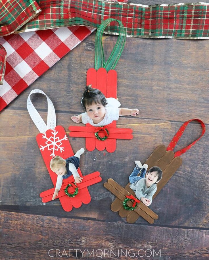 three christmas ornaments made out of popsicle sticks