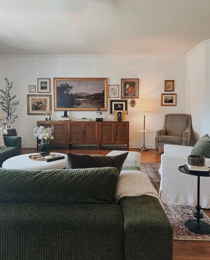 a living room filled with furniture and pictures on the wall