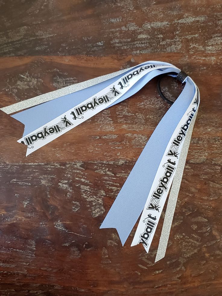 a ribbon with words on it sitting on a wooden table next to a cell phone