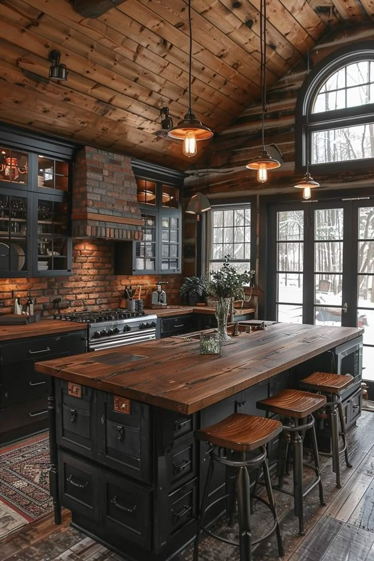 a kitchen with wooden floors and black cabinets