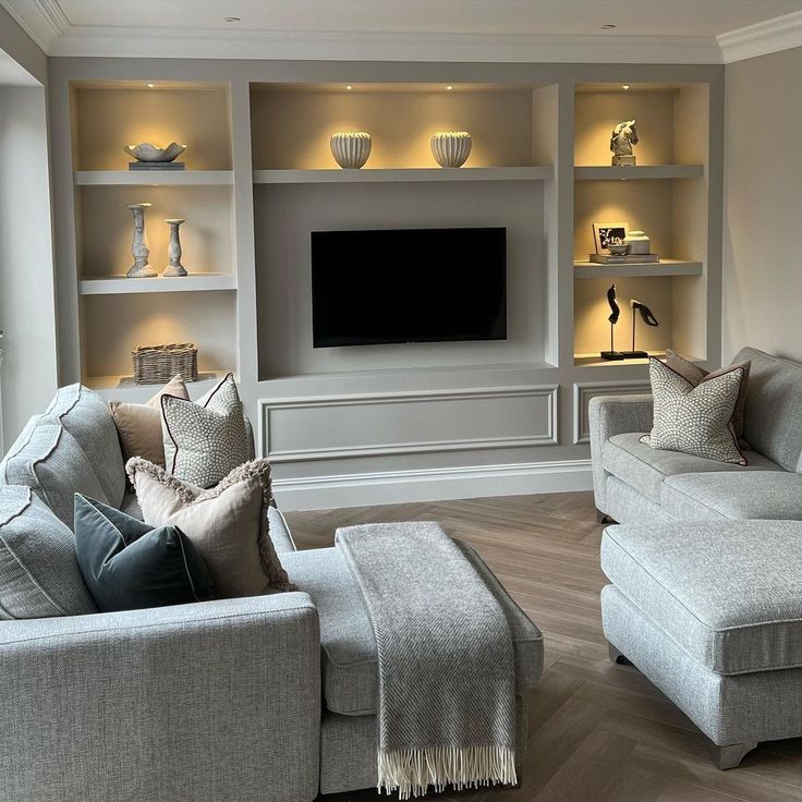 a living room filled with furniture and a flat screen tv mounted on a wall above it