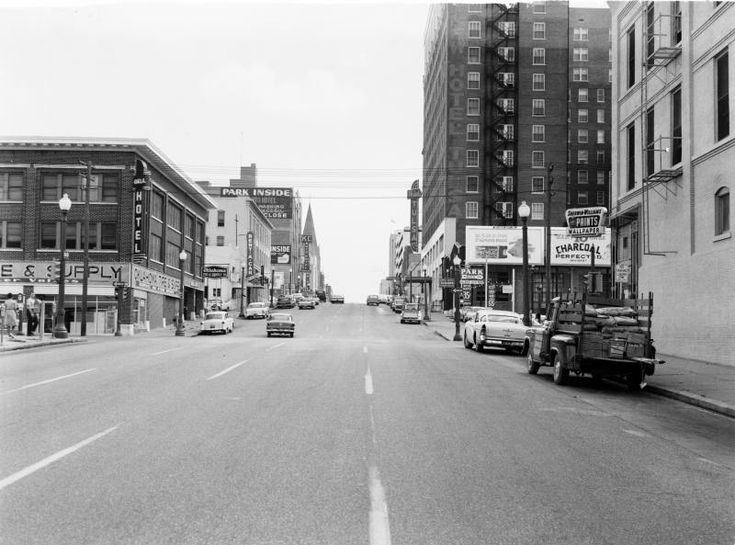 an old black and white photo of a city street