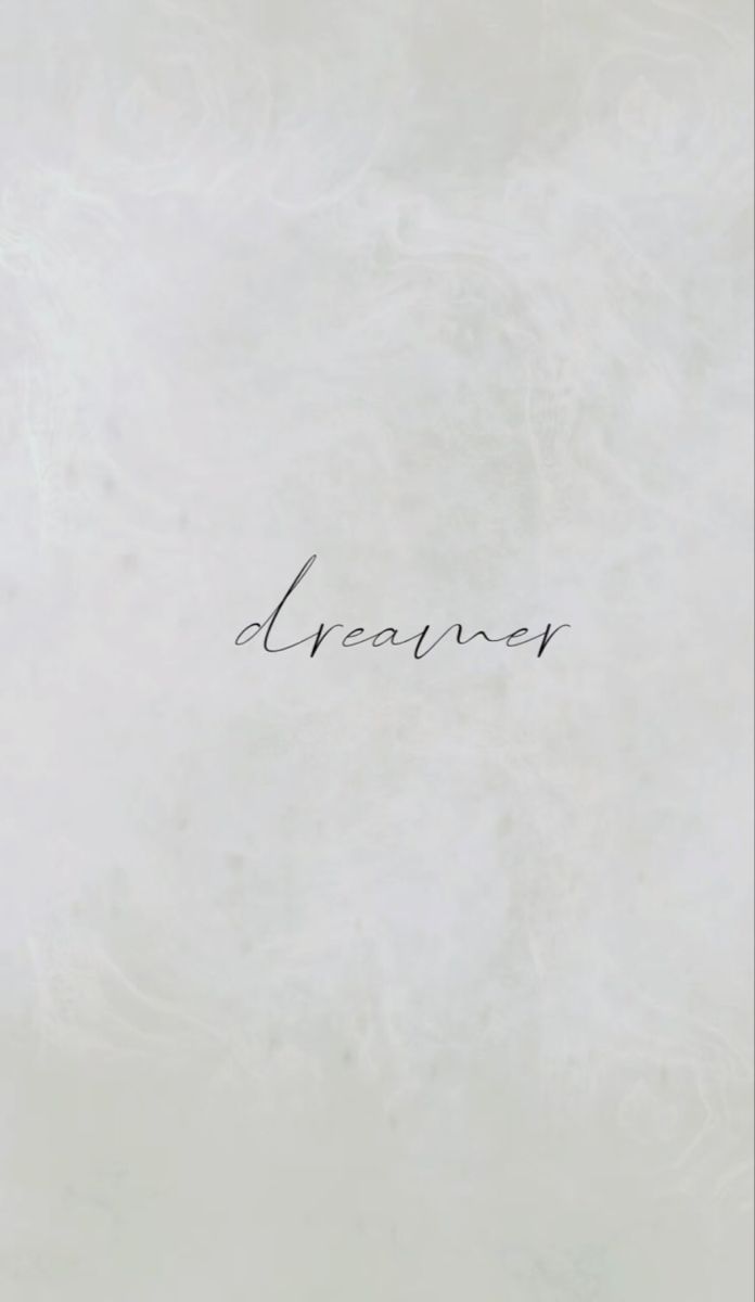 the word dream written in cursive writing on a white paper with black ink