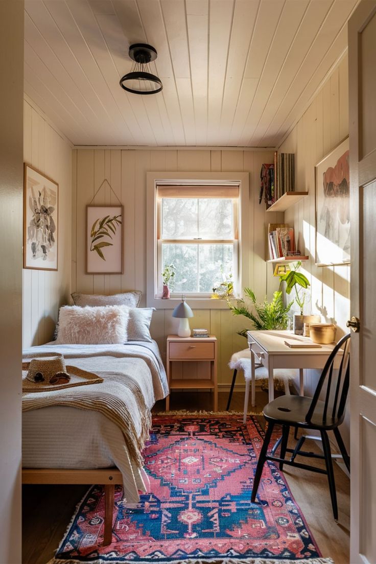 a bedroom with a bed, desk and chair next to a large rug on the floor