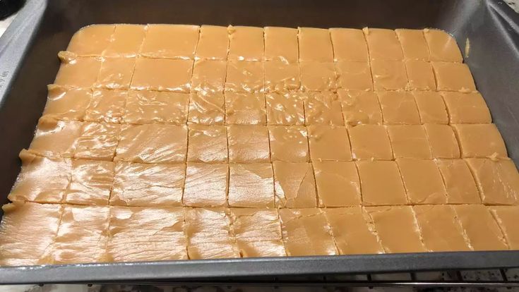 a pan filled with peanut butter squares on top of a stove