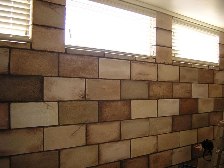 a wall made out of wooden blocks with windows and blinds on the window sill