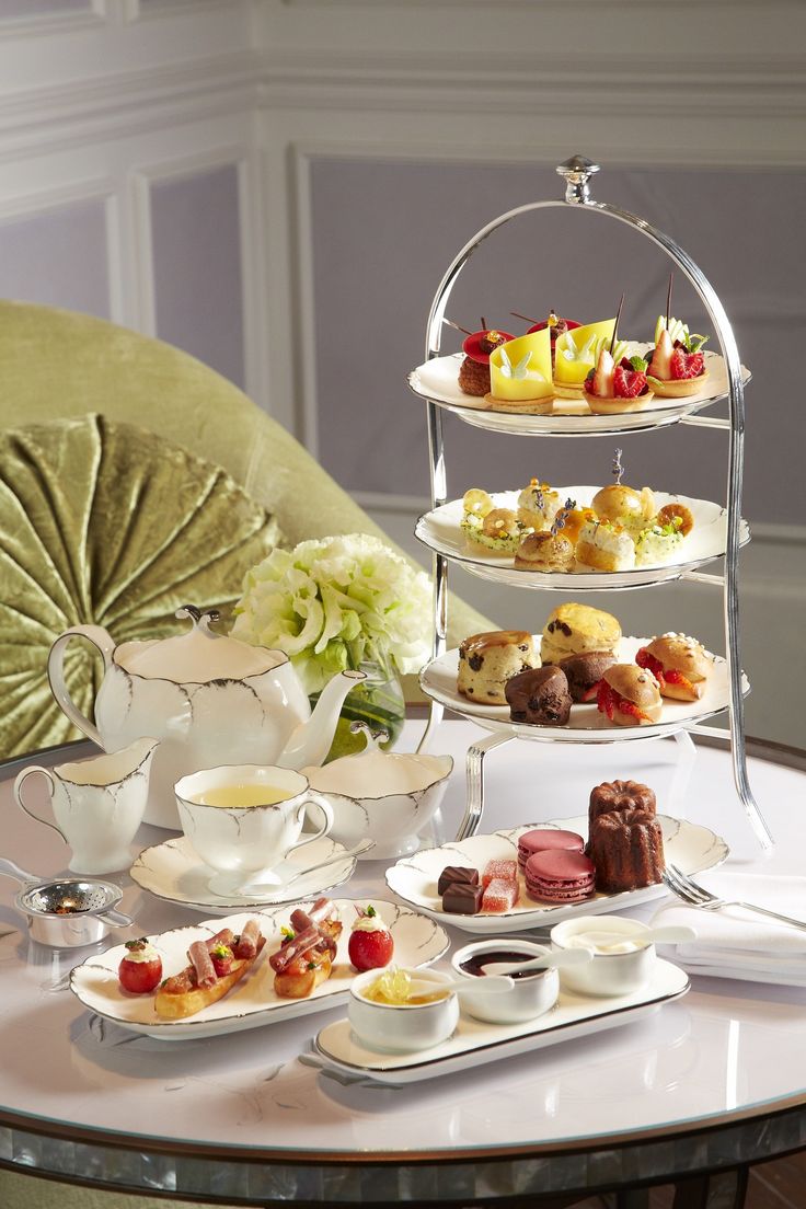 a table topped with lots of plates and cups filled with different types of desserts