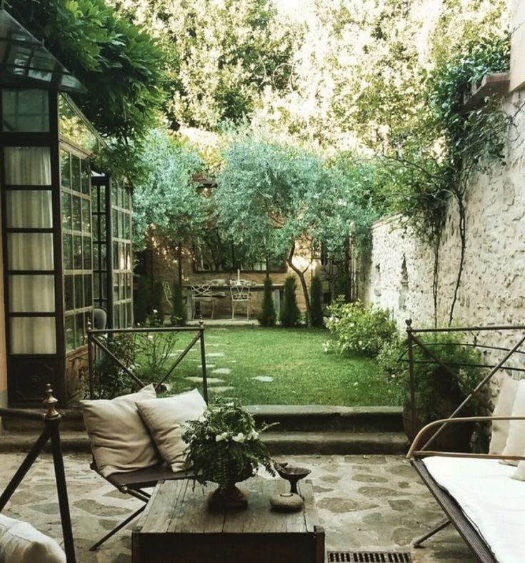 an outdoor living area with couches and tables