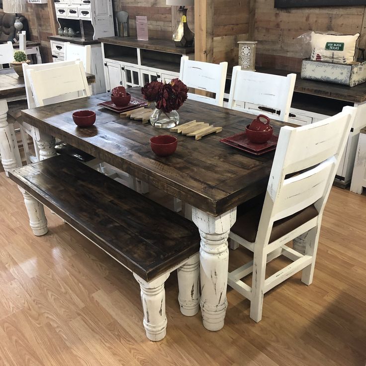 a dining room table with white chairs around it