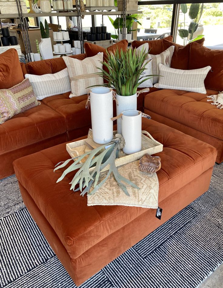 a living room filled with lots of couches and pillows on top of each other