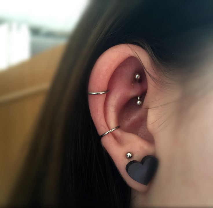 a woman with two piercings on her ear