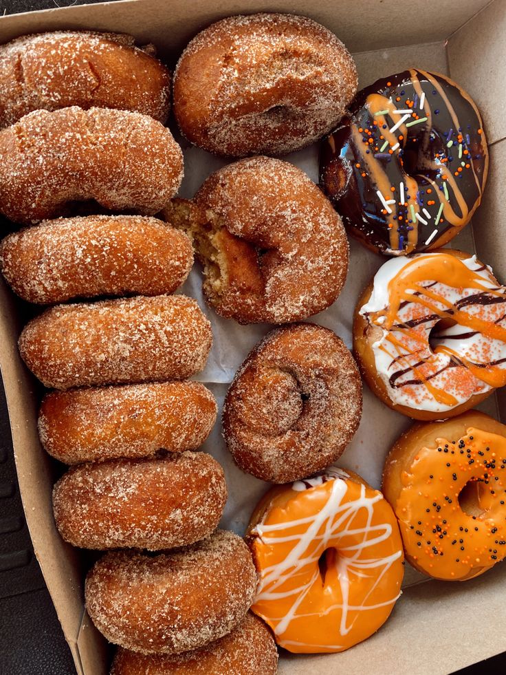 a box filled with lots of different flavored donuts