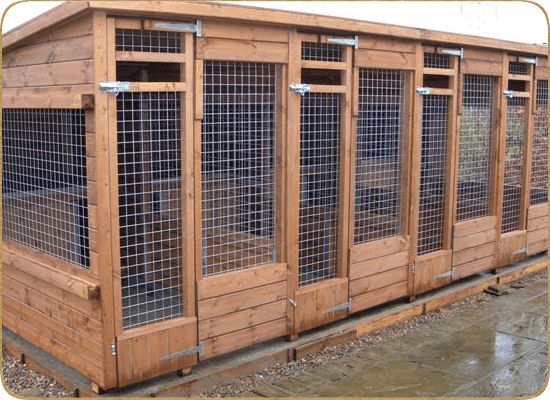 a dog kennel is made out of wood and has several windows on each side