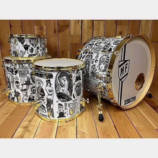 three drums are sitting on a wooden floor