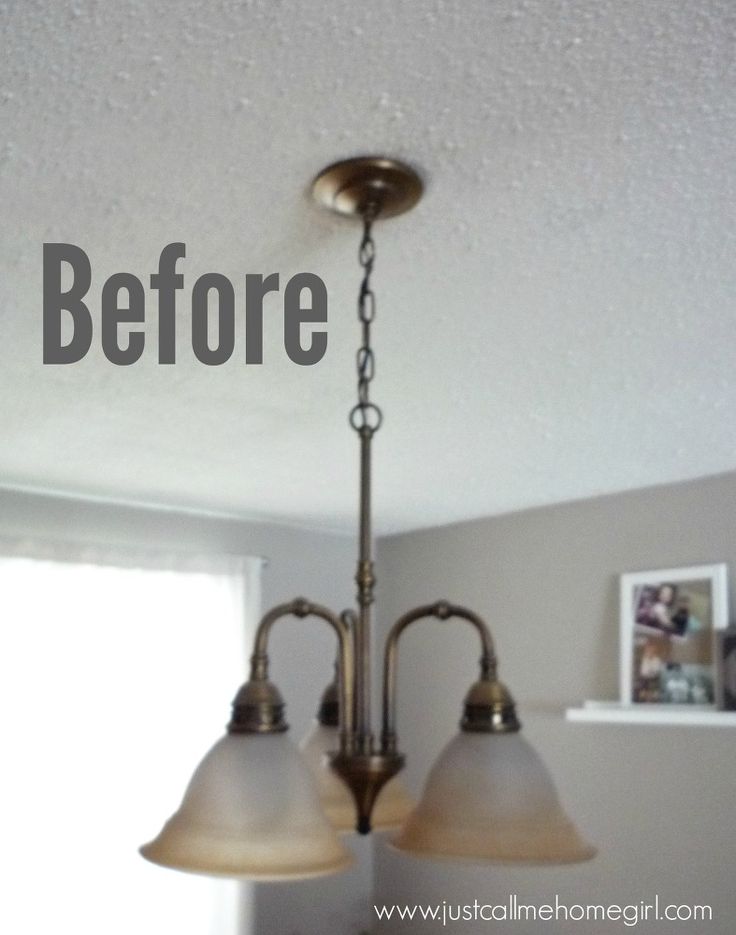 a chandelier hanging from the ceiling in a kitchen