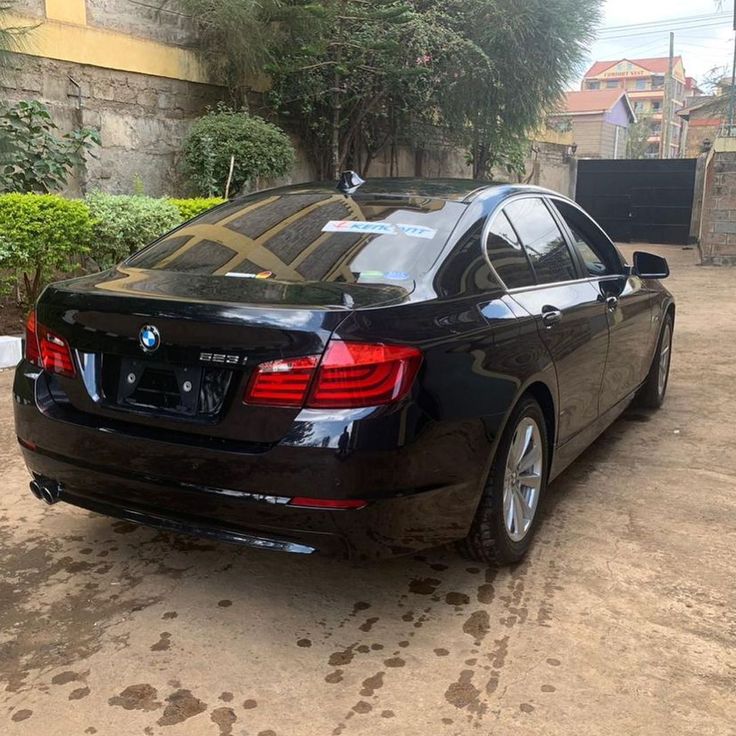 a black car parked in front of a building