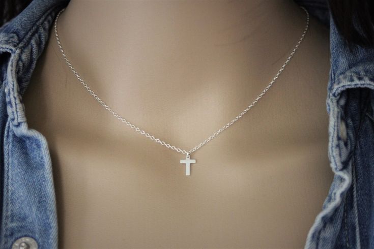 "Necklace in sterling silver small cross charm - minimalist silver necklace - silver cross choker Minimalist style fine sterling silver necklace. Necklace made with a chain in sterling silver 925/1000 embellished with a small cross pendant in sterling silver also. Silver cross size: 10mm X 7mm Adjustable length with the 4cm extension chain. Several lengths available. Feel free to contact me if you want another length. ♦ All my jewelry is made to order according to the dimensions you have chosen. Please check your measurements carefully. ♦ My jewelry is also delivered \"ready to offer\" and packaged in a pretty gift bag. Sending neat. For further information, please contact me via the tab \"contact the creator\" (response within 24 hours). creating EmmaFashionStyle No. Siret: 792 006 454 00 Minimalist Crucifix Jewelry With Delicate Chain, Dainty Silver Crucifix Jewelry, Dainty Silver Crucifix Necklace, Minimalist Sterling Silver Cross Necklace With Clavicle Chain, Dainty Sterling Silver Cross Necklace With Clavicle Chain, Simple Cross Jewelry With Delicate Chain, Delicate Sterling Silver Cross Pendant Necklace, Silver Minimalist Cross Necklace With Clavicle Chain, Minimalist Cross Pendant Charm Necklace