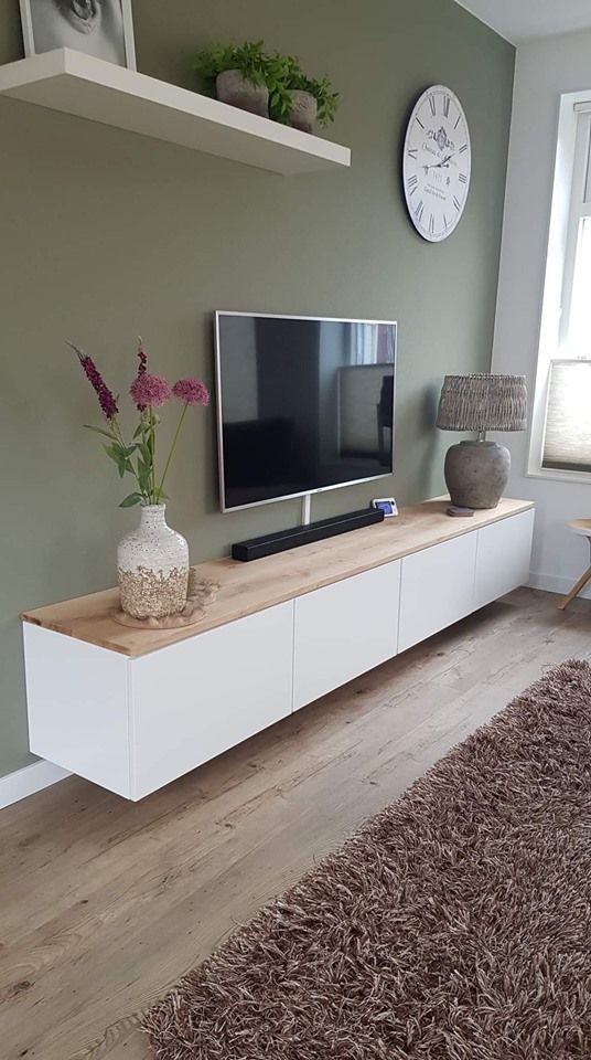 a flat screen tv sitting on top of a white entertainment center