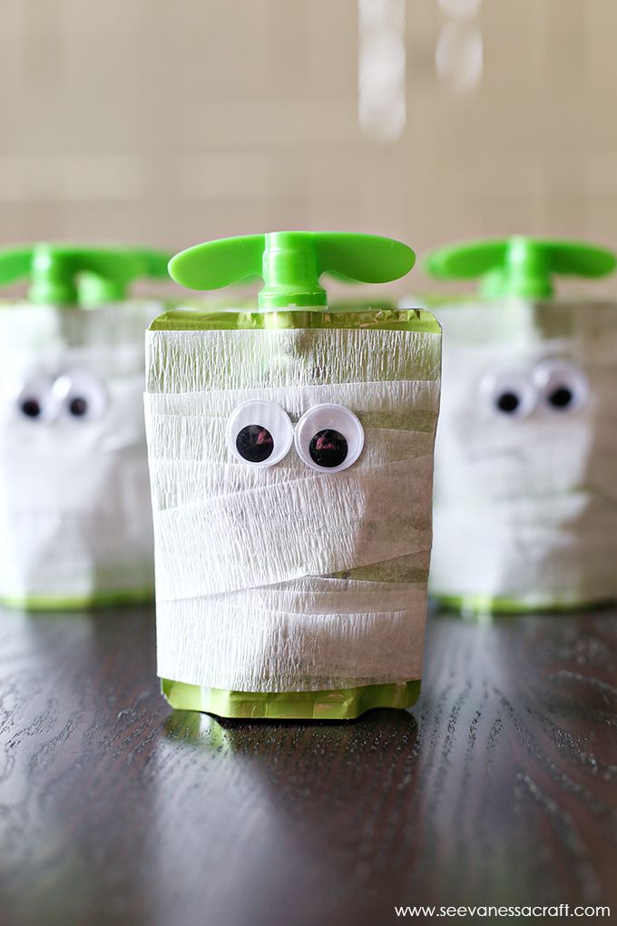 three toothbrush holders decorated to look like ghostes