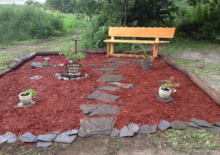 a wooden bench sitting in the middle of a garden