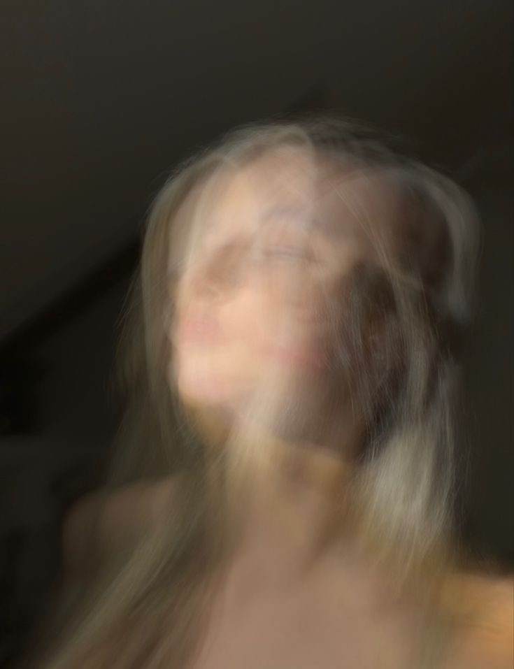 blurry photograph of a woman with long hair