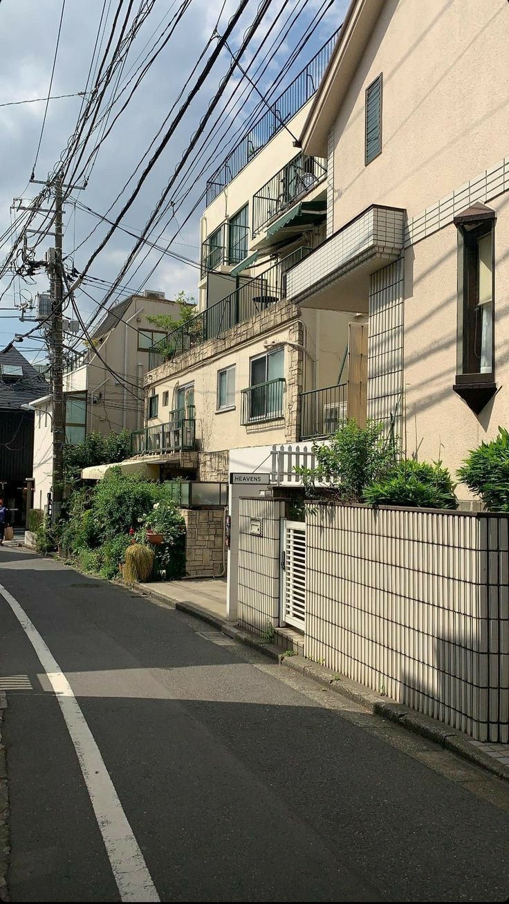 an empty street lined with houses and power lines