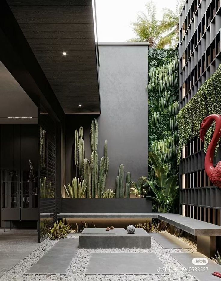 an outdoor courtyard with plants, rocks and benches