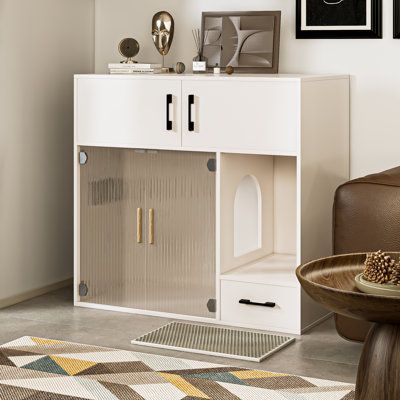 a white cabinet sitting on top of a living room floor