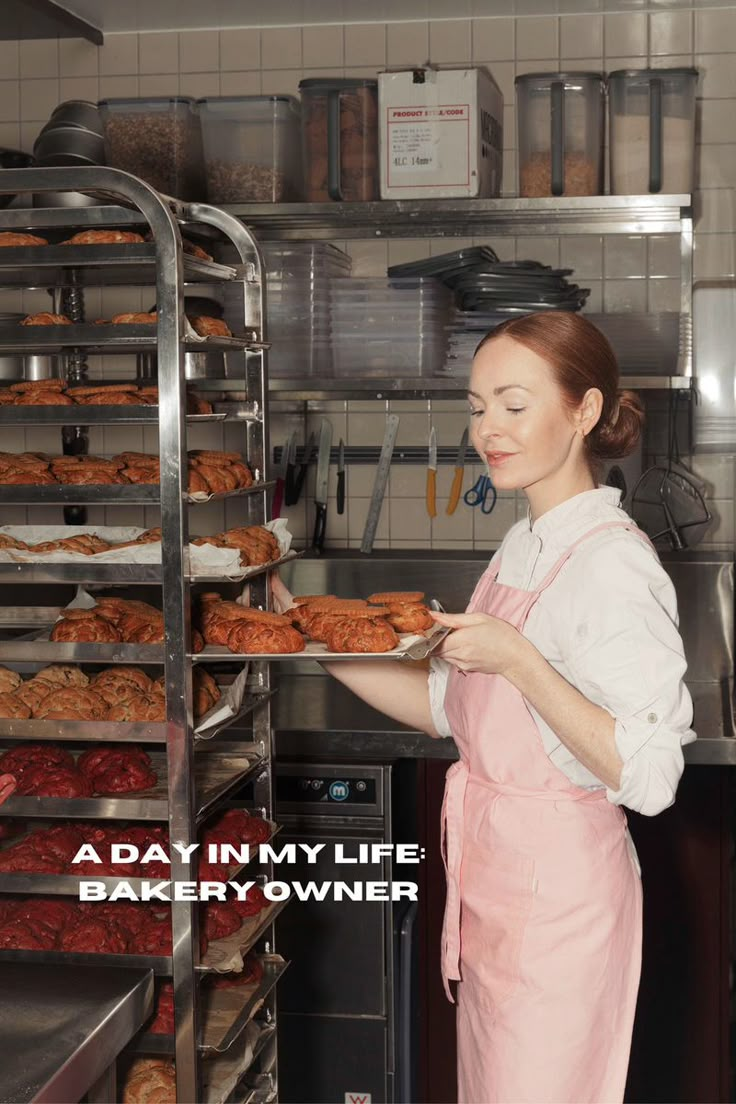 a woman in an apron holding a tray of doughnuts with the words, a day in my life bakery owner