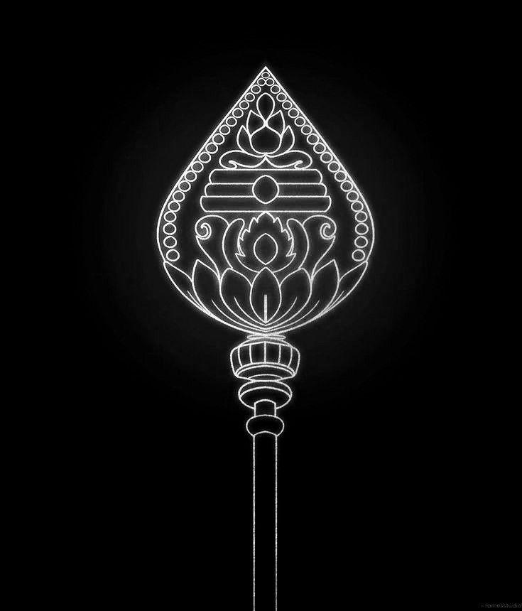 a black and white photo of a lamp in the dark with an intricate design on it