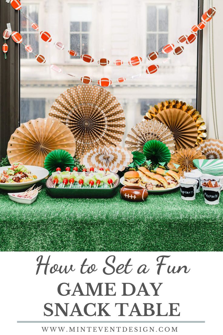 an image of a game day snack table with paper fans and food on the table