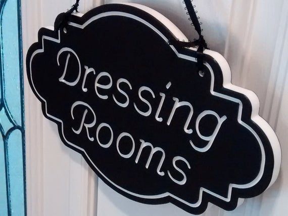 a sign that says dressing rooms hanging on a door