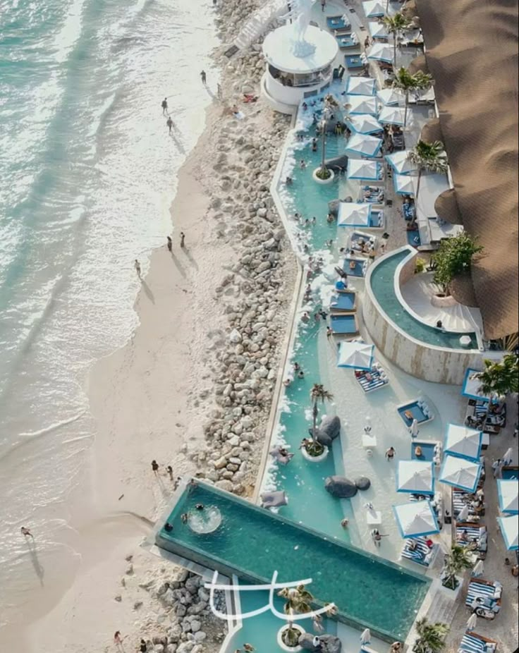 an aerial view of the beach and pool