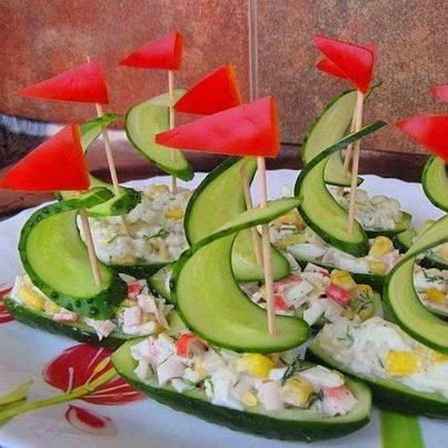 cucumber boats with red flags are on a plate