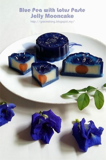 blue pea with lotus park jelly mooncake on a white plate next to purple flowers