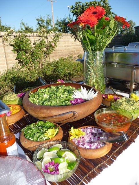 a table full of different types of salads and condiments on top of it