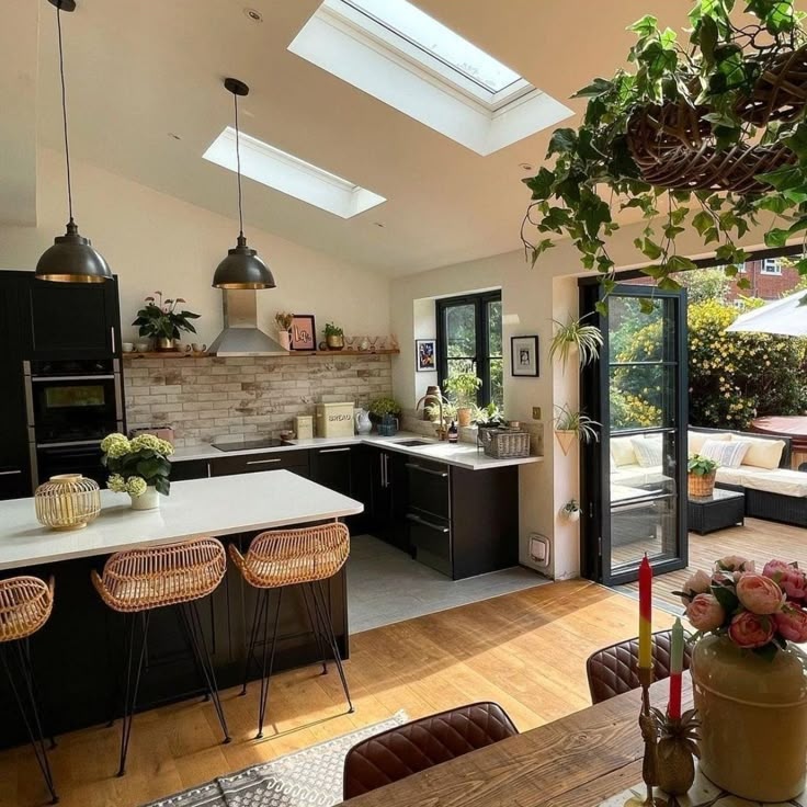 an open kitchen and dining room with skylights