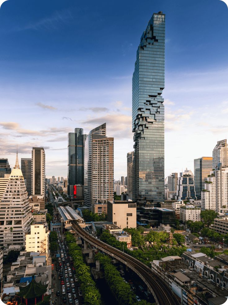 an aerial view of a city with skyscrapers and train tracks