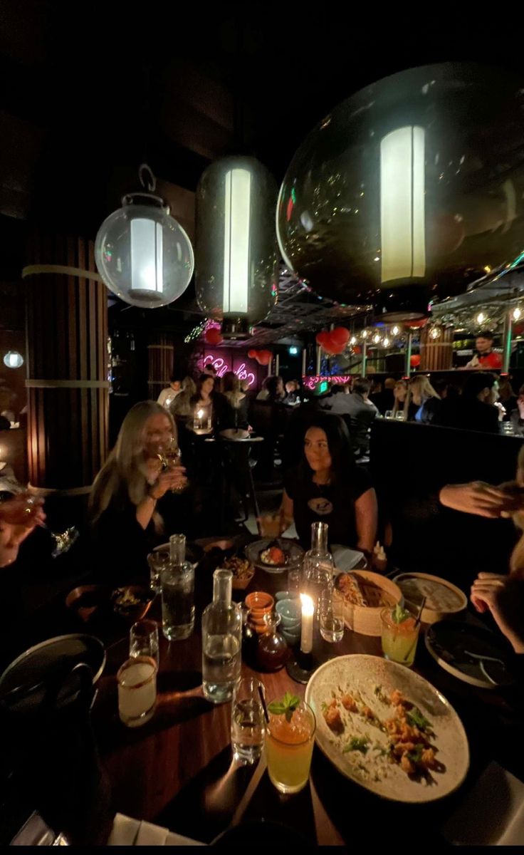 a group of people sitting around a dinner table