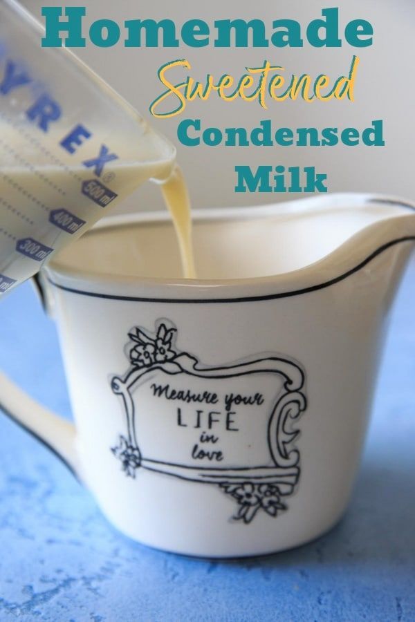 homemade sweetened condensed milk being poured into a pitcher