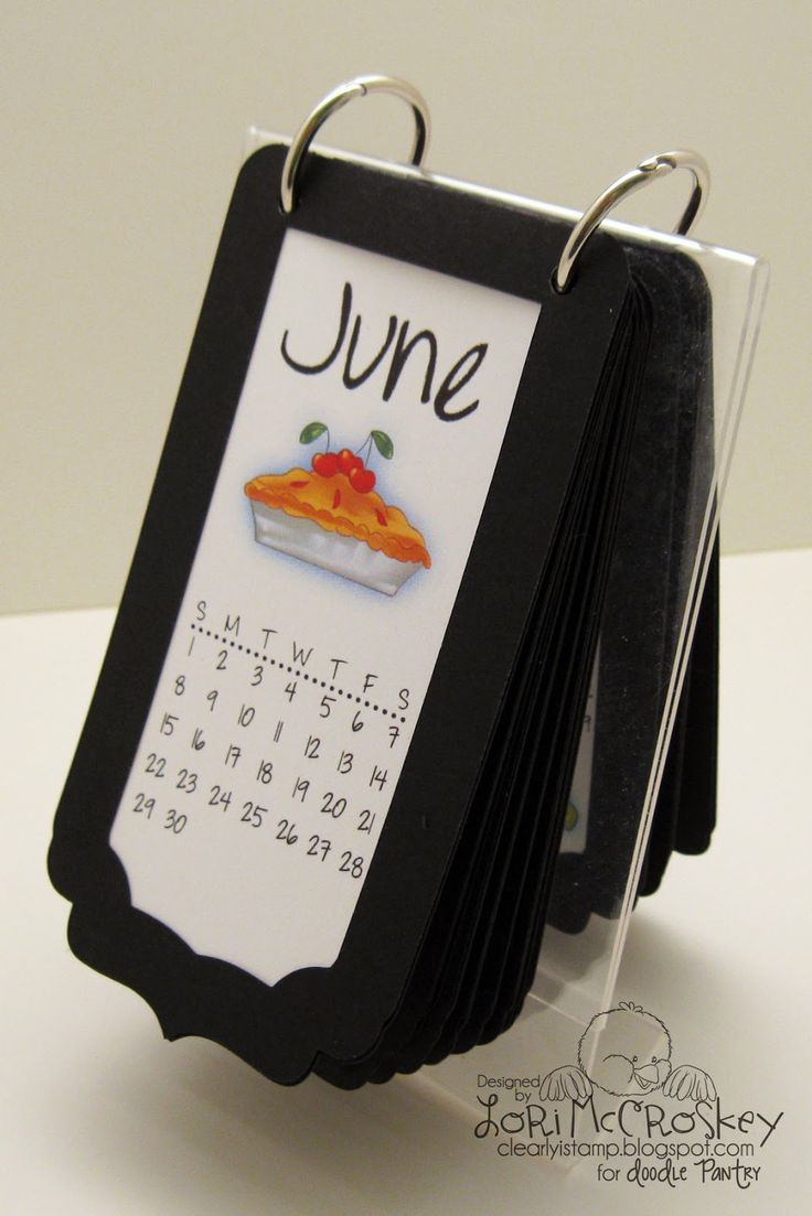 a black and white calendar with a piece of pie on it's back side