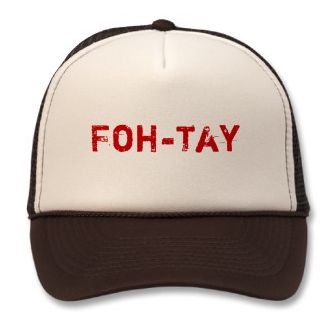 a white and brown trucker hat with the word foh - tay printed on it