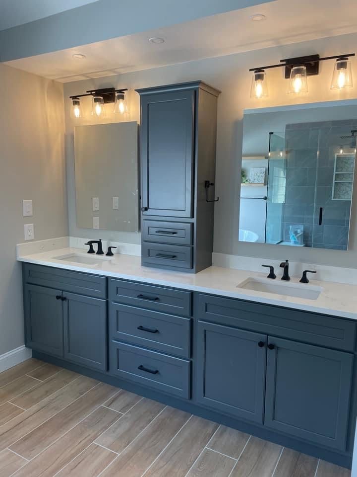 a bathroom with double sinks and two mirrors