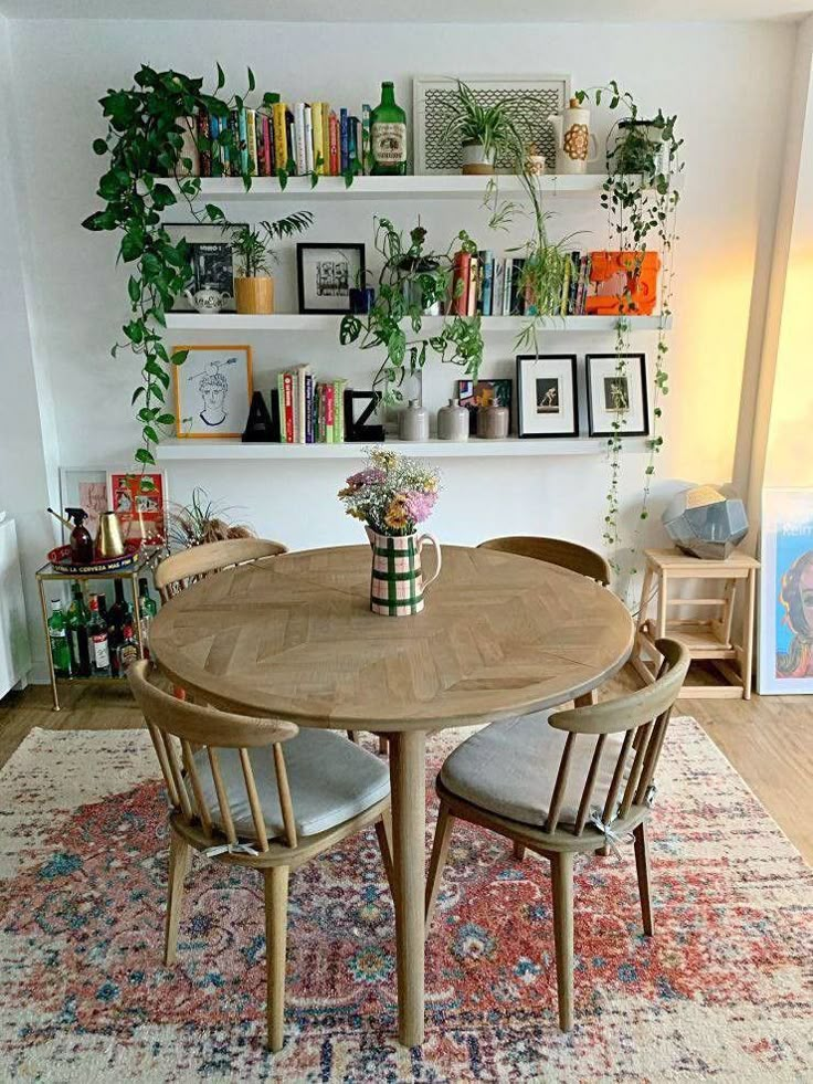 a dining room table and chairs with bookshelves in the background