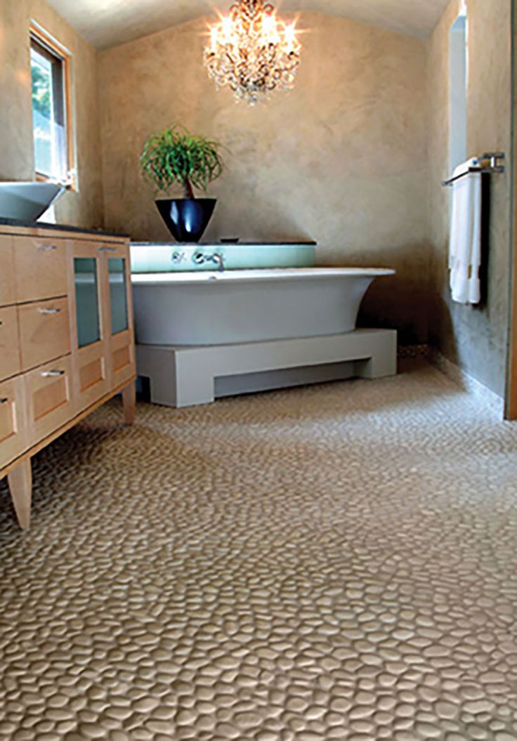 a bathroom with a tub, sink and chandelier hanging from it's ceiling