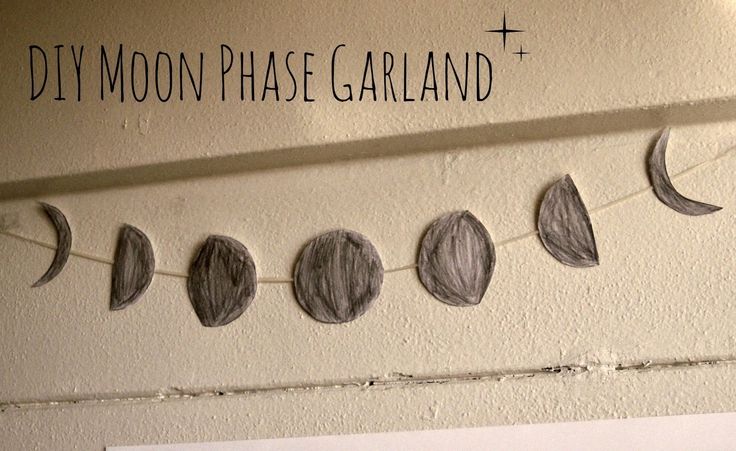 a string of paper moon phases hanging on a wall with the words diy moon phase garland above it